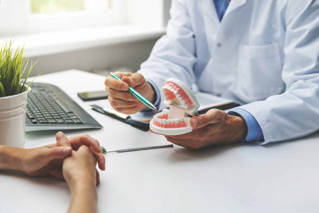 Dentist And Patient Discussion About Planned Teeth Treatment In Dental Clinic Office