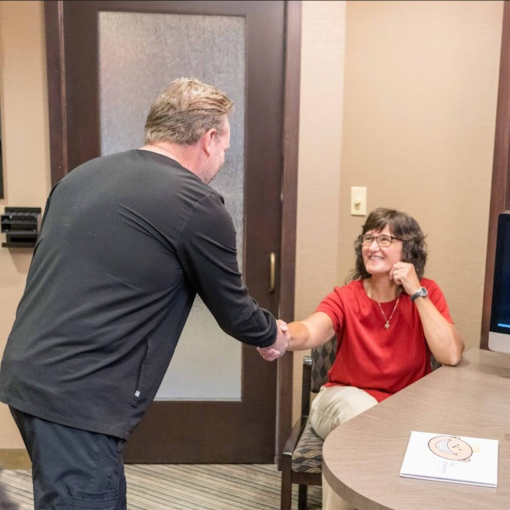 Dr Miller Shaking Hands With Patient