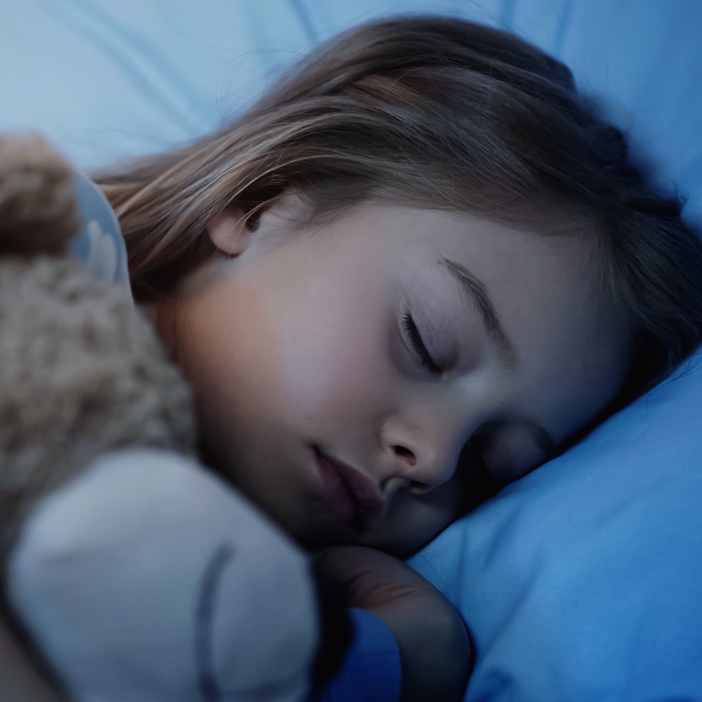 Young Girl Sleeping Soundly With Teddy Bear