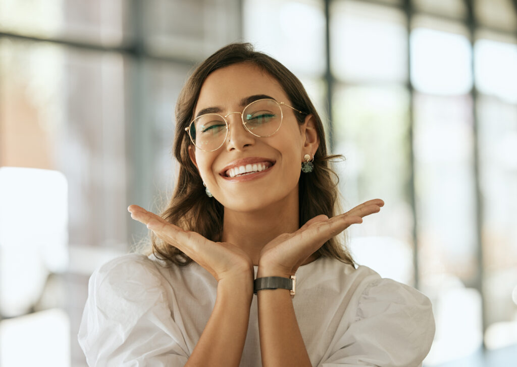 Photogenic stylish woman framing her aesthetic smile with her hands