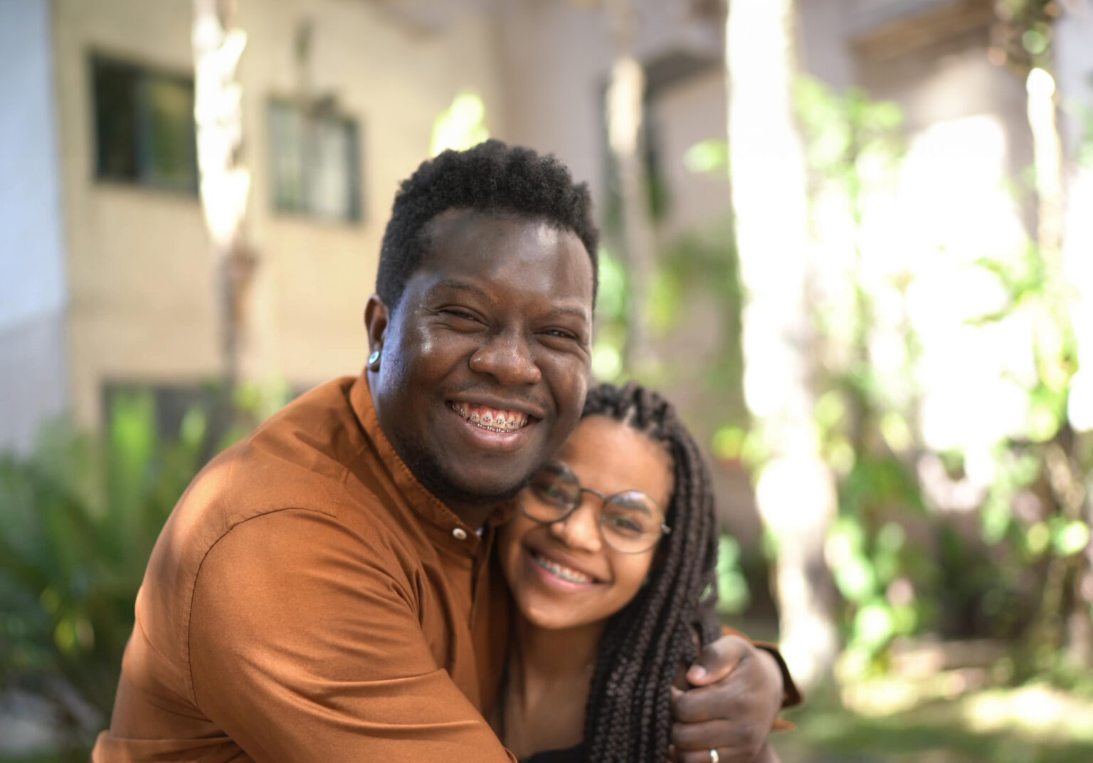 Portrait of father and daughter embracing outside